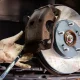 Mechanic performing a brake inspection and brake repair on a car at an auto repair shop