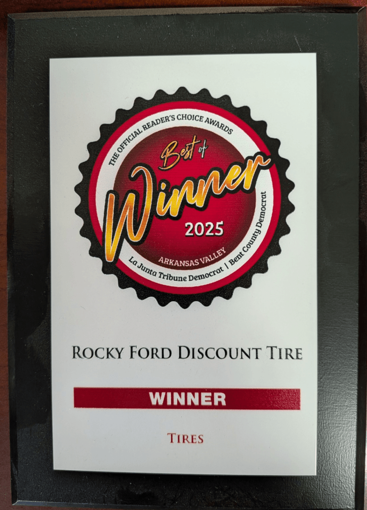 A plaque with a circular emblem reading Best of Winner 2025 and text that says Rocky Ford Discount Tire, Winner, Tires from the Arkansas Valley La Junta Tribune Democrat—celebrating excellence in Rocky Ford.